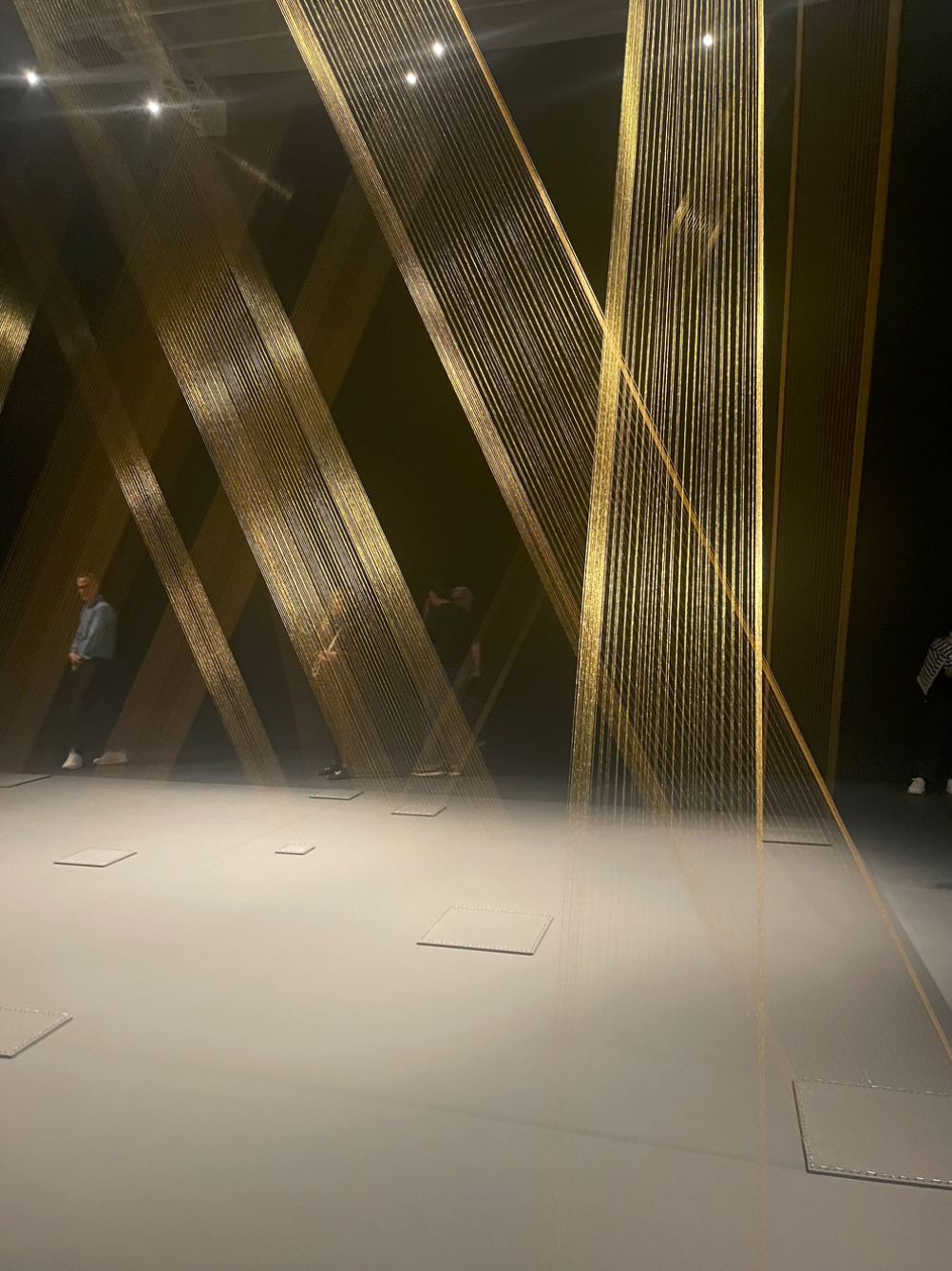 Installation view of Lygia Pape, "Ttéia 1, C" (2003–25), golden thread, wood, nails, light, dimensions variable (photo by Eurídice Arratia/Hyperallergic)